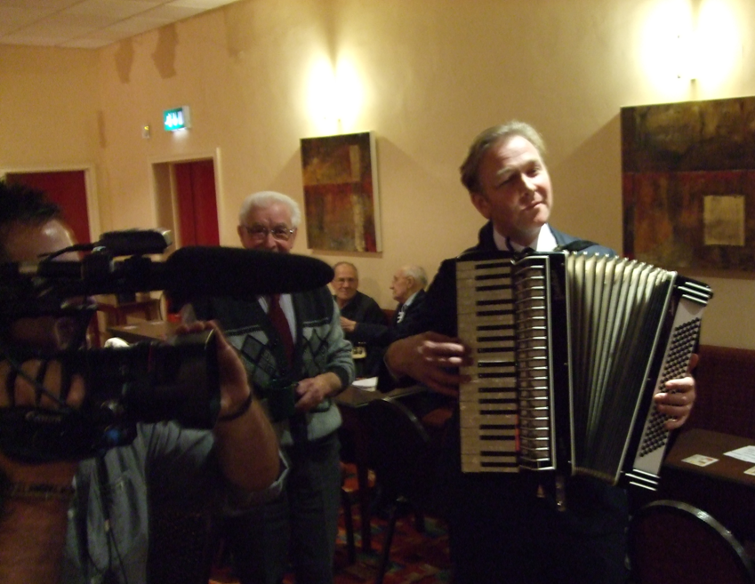 Paul Hayes Demonstrating the Accordion That Is about to be auctioned